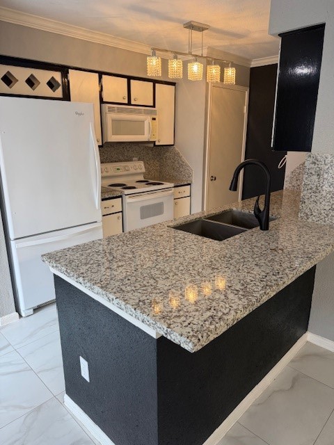 a kitchen with granite countertop a sink a stove and a refrigerator