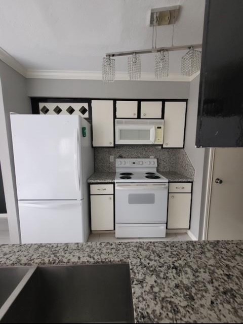 2211 South Kirkwood Road, Unit 69 Houston, TX 77077 - Photo 4 of 9 a kitchen with a refrigerator and a stove