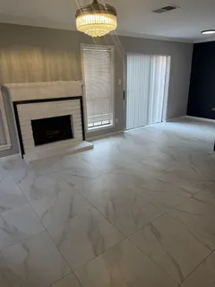 a view of empty room with fireplace and window
