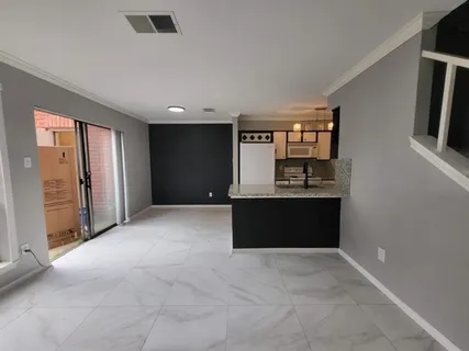 a view of kitchen with refrigerator and window