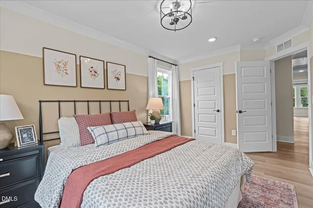 a bedroom with a bed and a chandelier