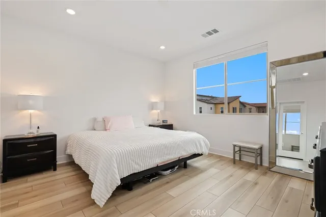 a bedroom with a bed and a night stand