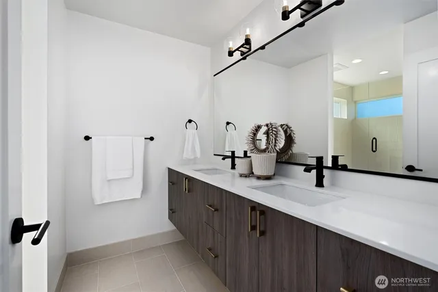 a bathroom with a double vanity sink and a mirror