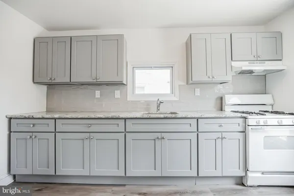 a kitchen with white cabinets