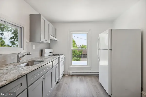 a kitchen with a sink stove and refrigerator