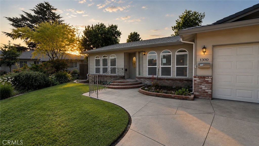 1300 Kensington Drive Merced, CA 95340 - Photo 2 of 10 a view of a house with backyard sitting area and garden