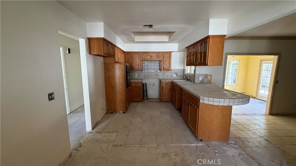 1300 Kensington Drive Merced, CA 95340 - Photo 5 of 10 a kitchen with stainless steel appliances granite countertop a refrigerator and a stove