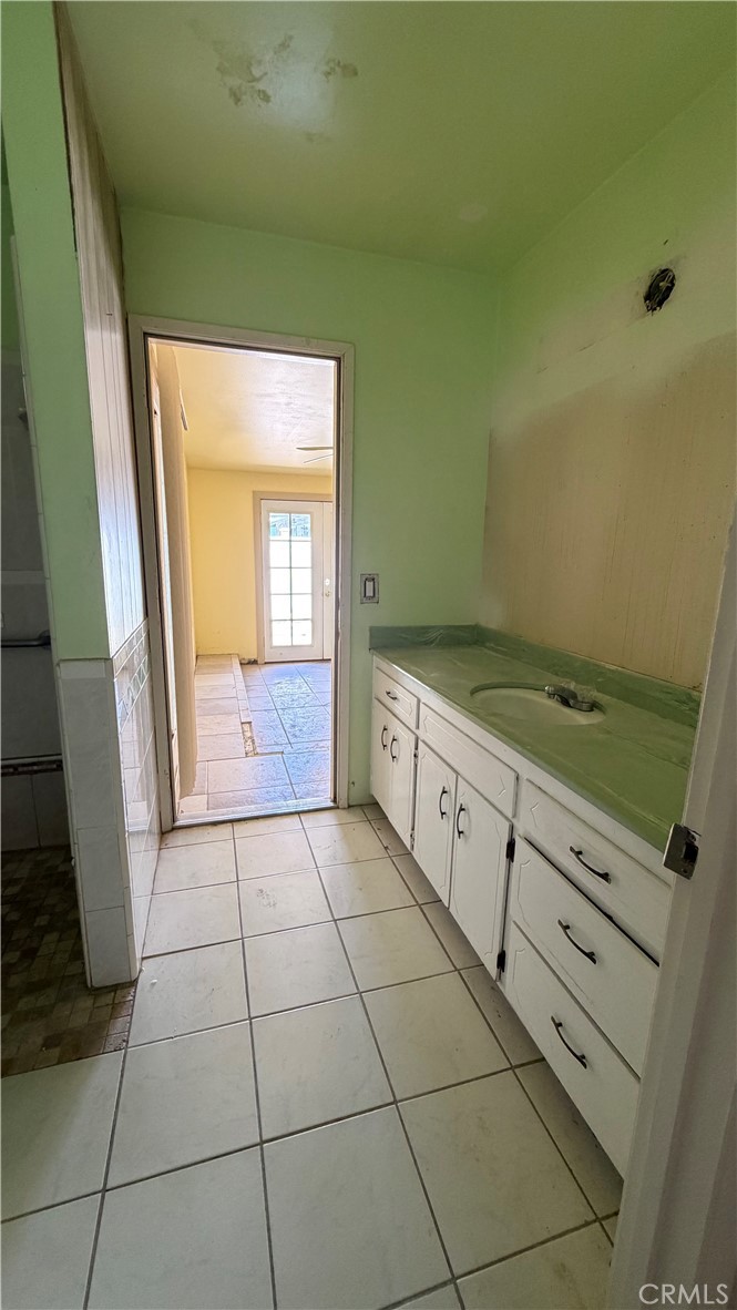 1300 Kensington Drive Merced, CA 95340 - Photo 7 of 10 a hallway with a washer and dryer