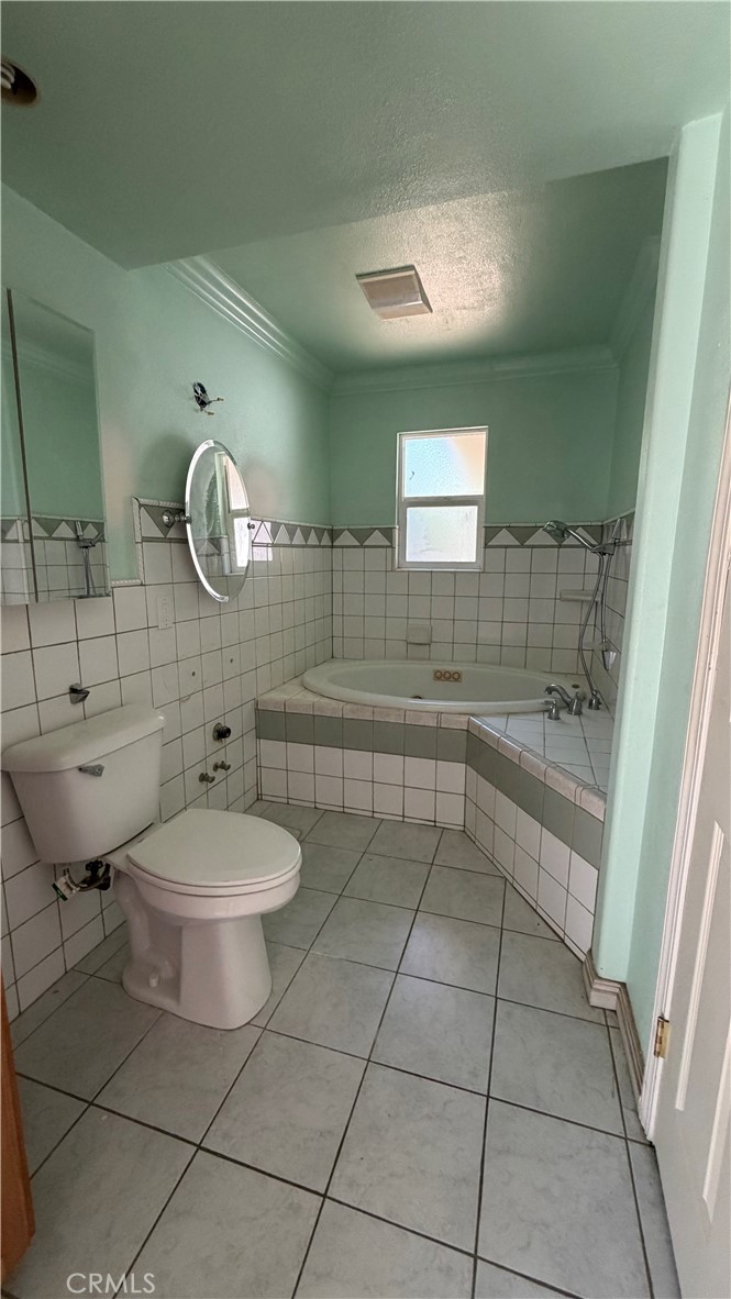 1300 Kensington Drive Merced, CA 95340 - Photo 9 of 10 a bathroom with a toilet a sink and mirror