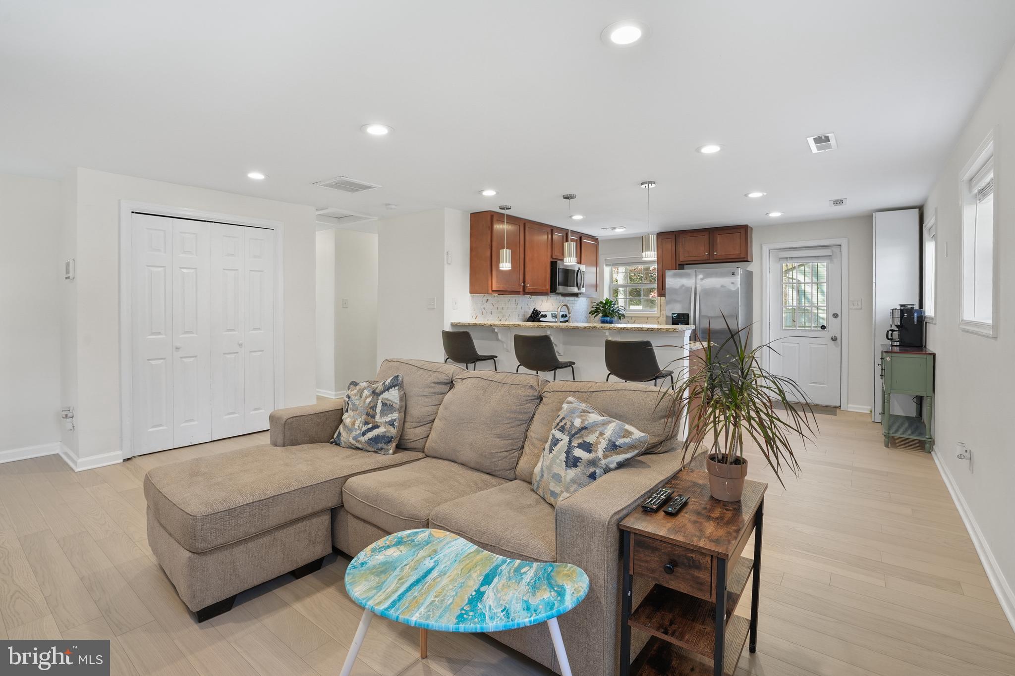 15709 Maple Drive Accokeek, MD 20607 - Photo 16 of 48 a living room with furniture a fireplace and a flat screen tv