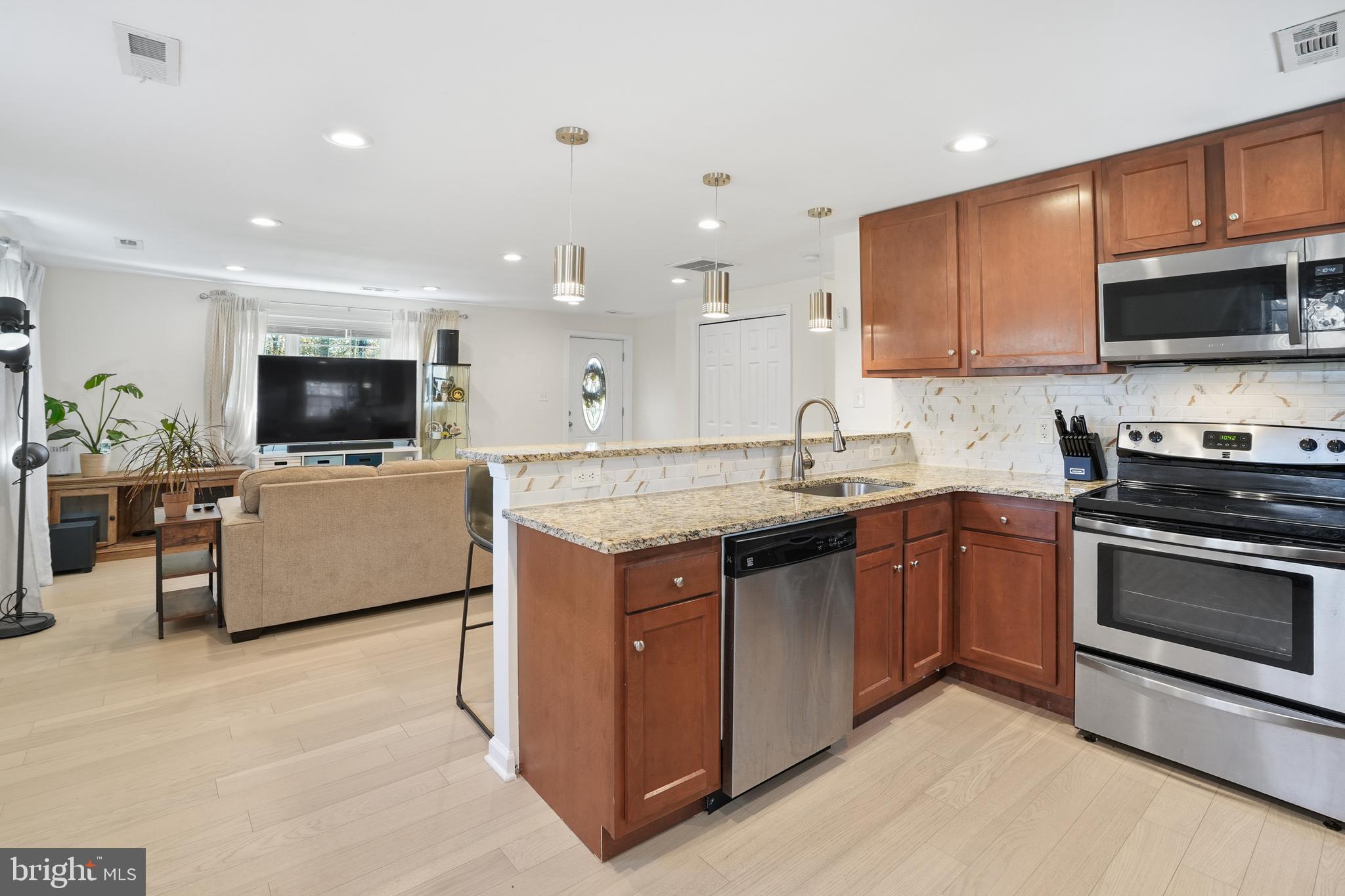 15709 Maple Drive Accokeek, MD 20607 - Photo 19 of 48 a kitchen with a sink stove and microwave