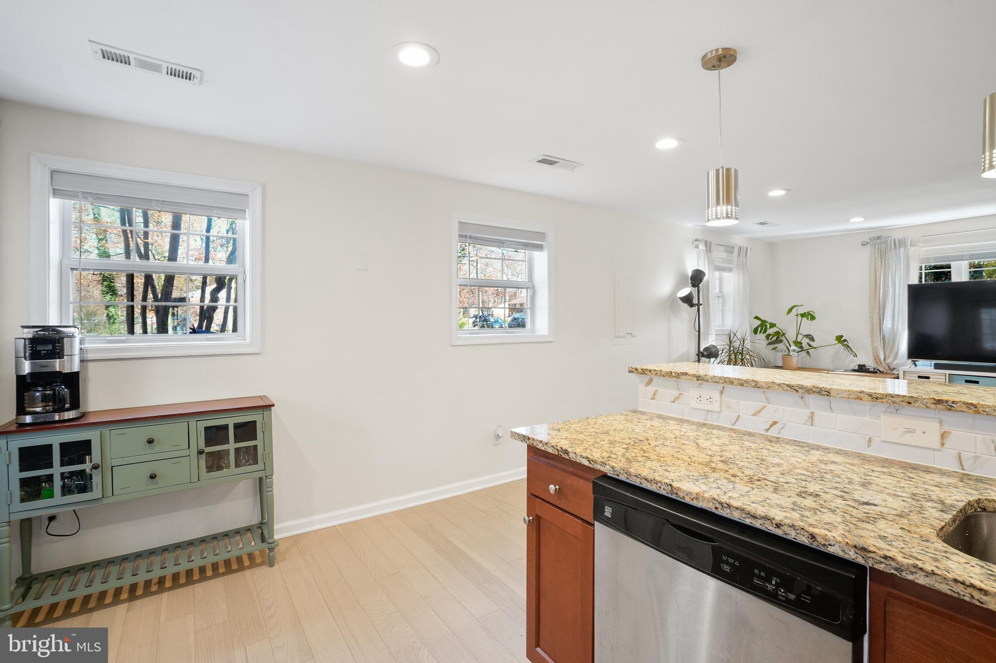 15709 Maple Drive Accokeek, MD 20607 - Photo 20 of 48 a view of a kitchen counter top space with stainless steel appliances granite countertop a sink and a wooden floor