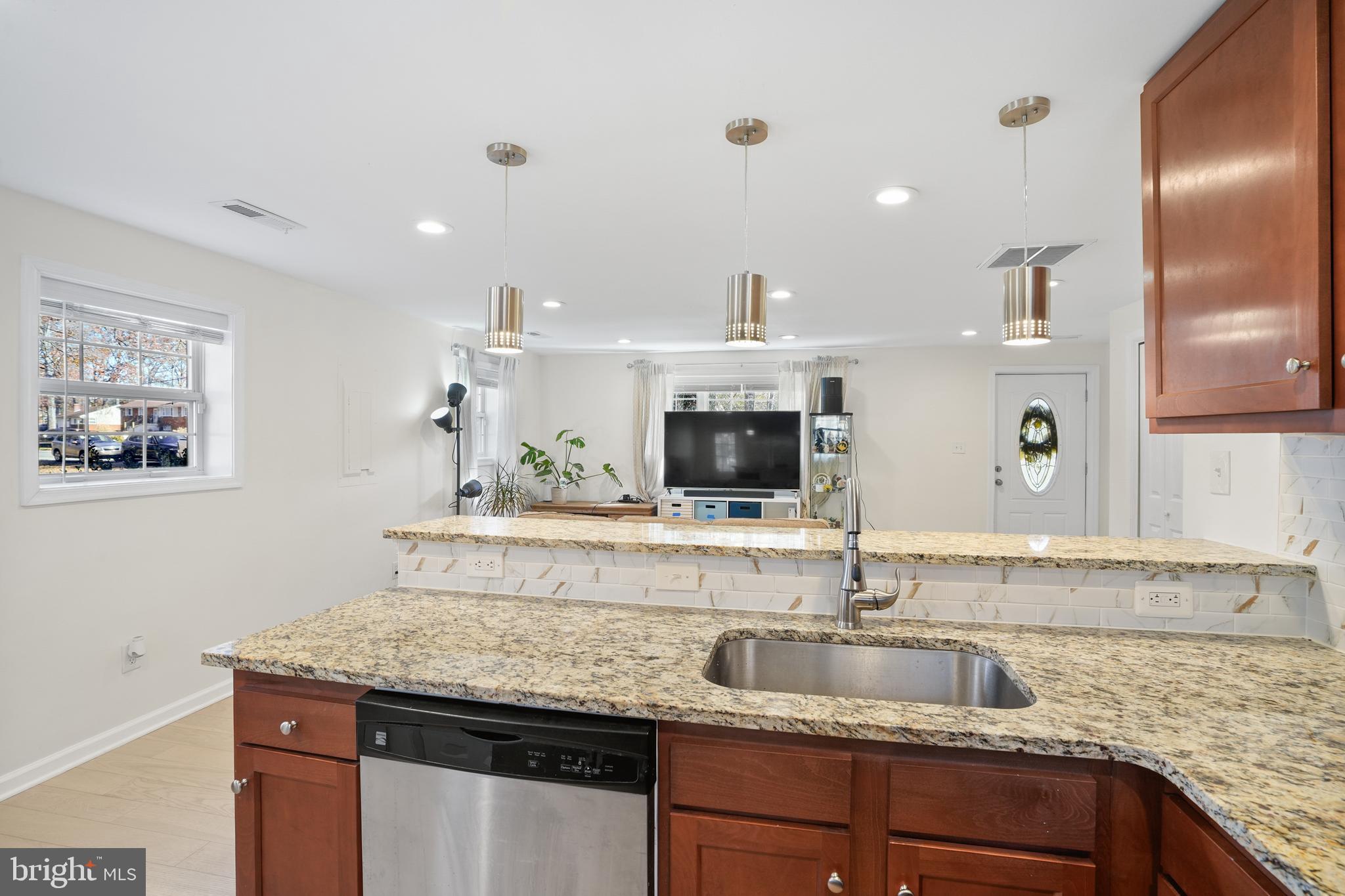 15709 Maple Drive Accokeek, MD 20607 - Photo 21 of 48 a kitchen with a sink and a refrigerator
