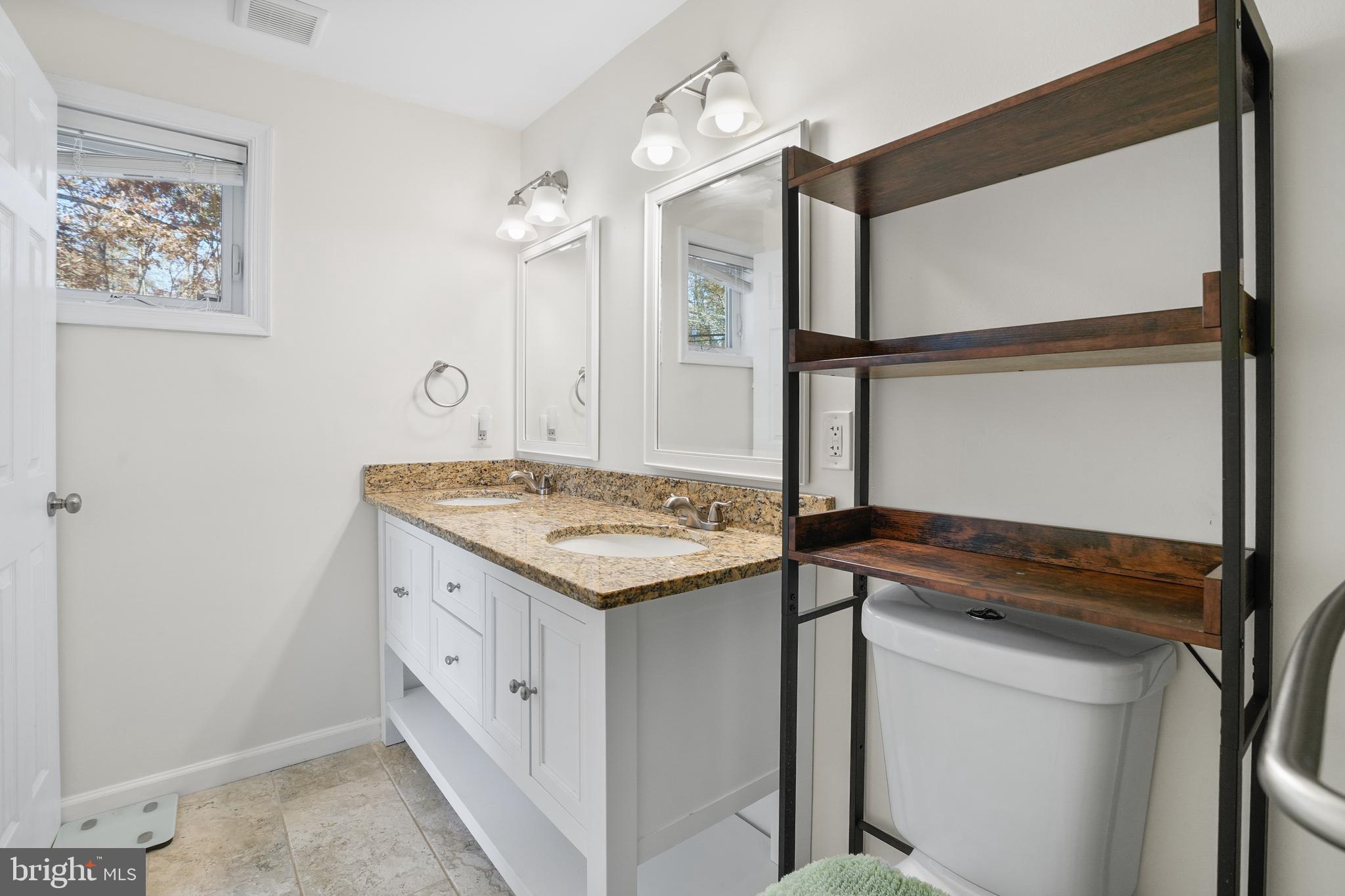 15709 Maple Drive Accokeek, MD 20607 - Photo 30 of 48 a kitchen with a stove and a refrigerator