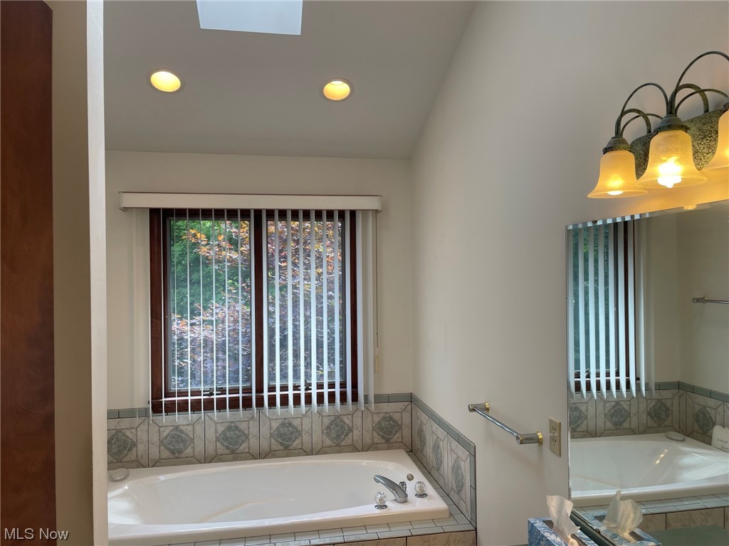 4088 Leffingwell Road Canfield, OH 44406 - Photo 26 of 35 Bathroom featuring tiled tub and lofted ceiling