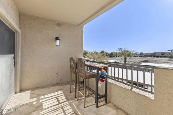 a balcony with wooden floor and city view