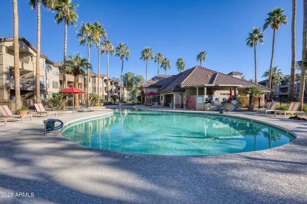 a view of a swimming pool with outdoor seating
