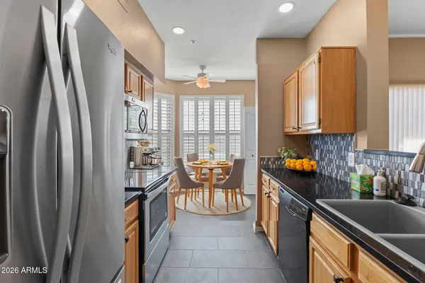 a kitchen with granite countertop a sink a stove and a wooden floors