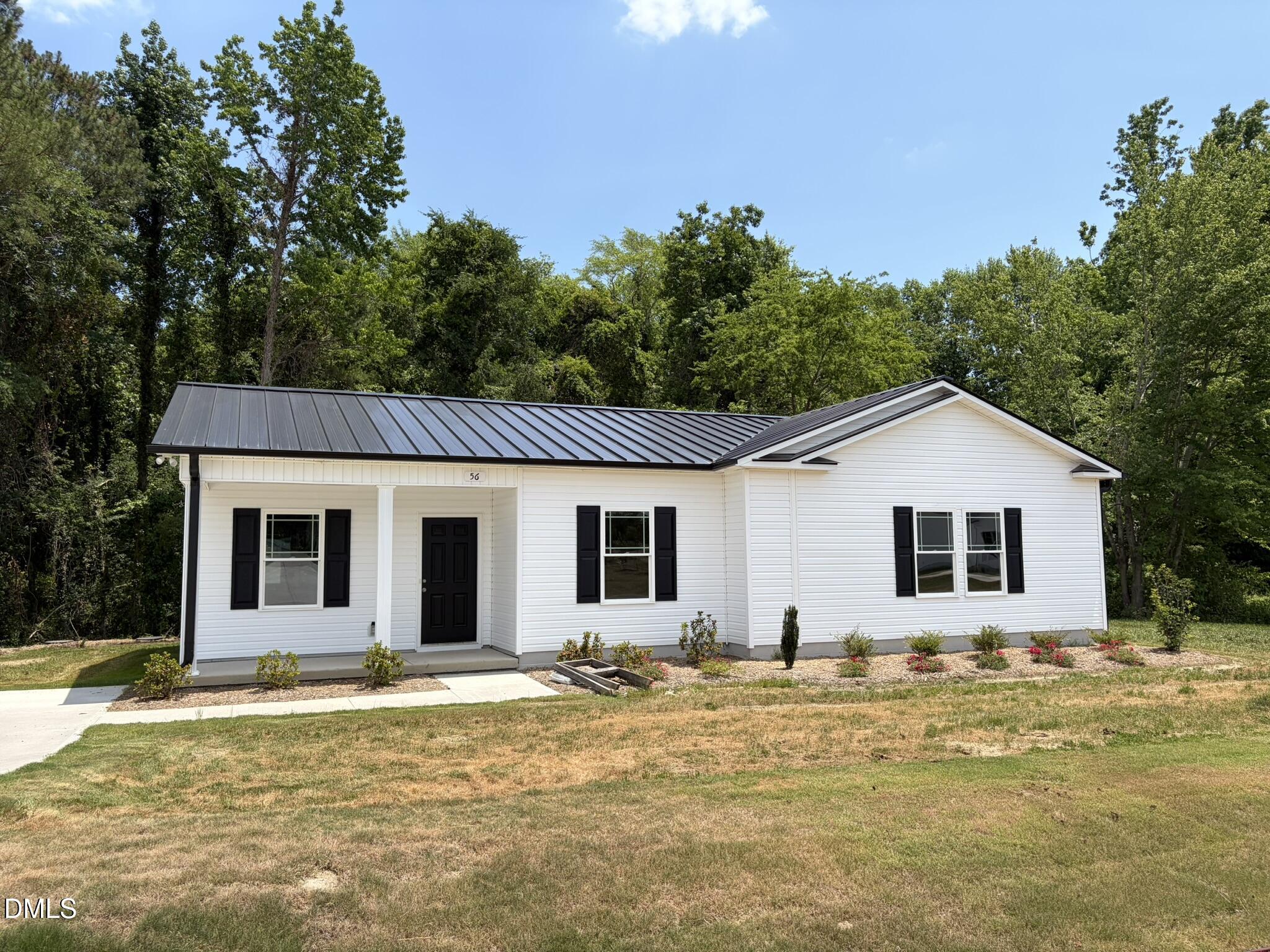56 Jacobs Ridge Drive Four Oaks, NC 27524 - Photo 1 of 19 a front view of house with yard and trees