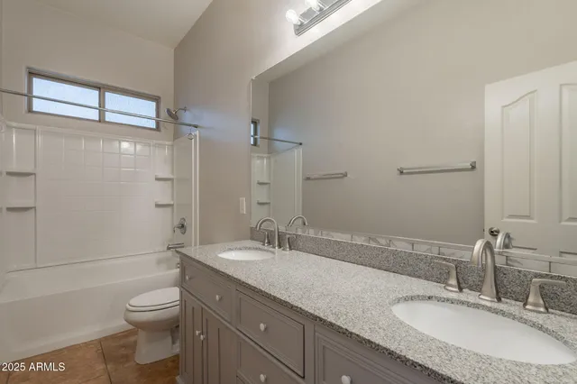 a bathroom with a tub shower vanity and a sink