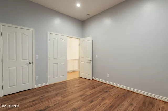 a view of a hallway with wooden shelves