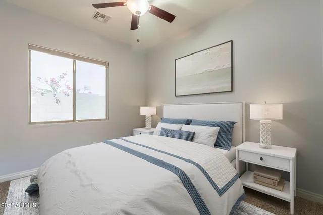 a bathroom with a granite countertop toilet a sink and a large mirror