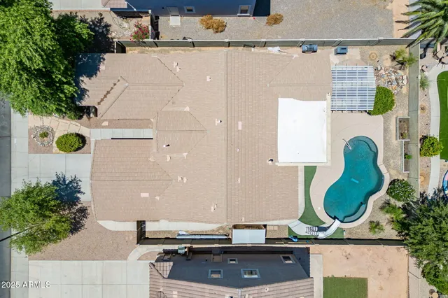 an aerial view of a house with a swimming pool
