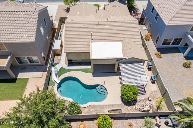 a swimming pool with outdoor seating and yard