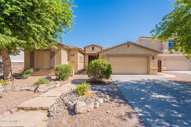 a front view of a house with a yard and a garage