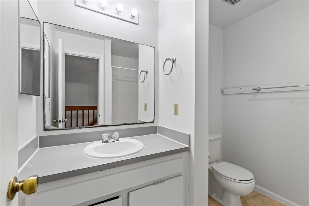 2219 Southwest 39th Way Gainesville, FL 32607 - Photo 11 of 17 a bathroom with a sink and a mirror with toilet