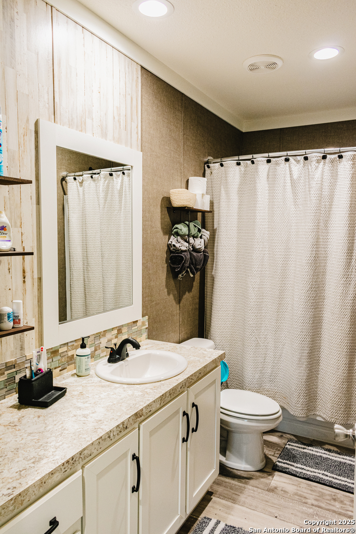 342 PR 4653 Hondo, TX 78861 - Photo 20 of 35 a bathroom with a granite countertop sink toilet and shower