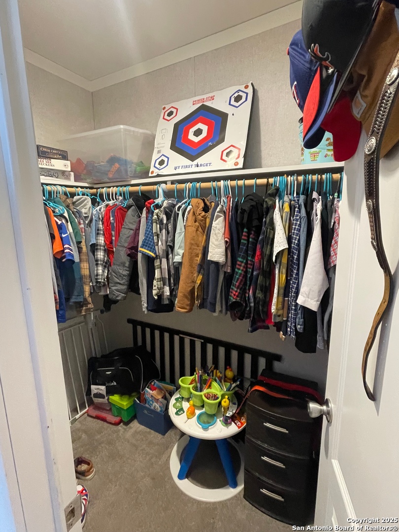 342 PR 4653 Hondo, TX 78861 - Photo 23 of 35 a view of walk in closet with clothes