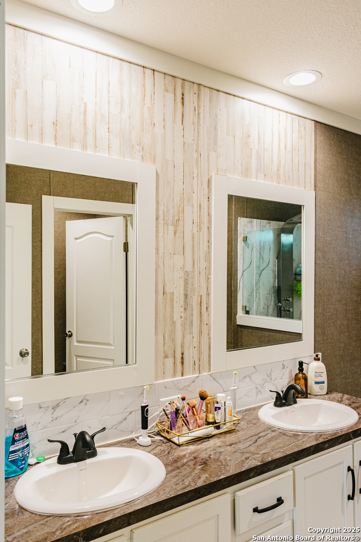 342 PR 4653 Hondo, TX 78861 - Photo 33 of 35 a bathroom with a granite countertop sink and a mirror