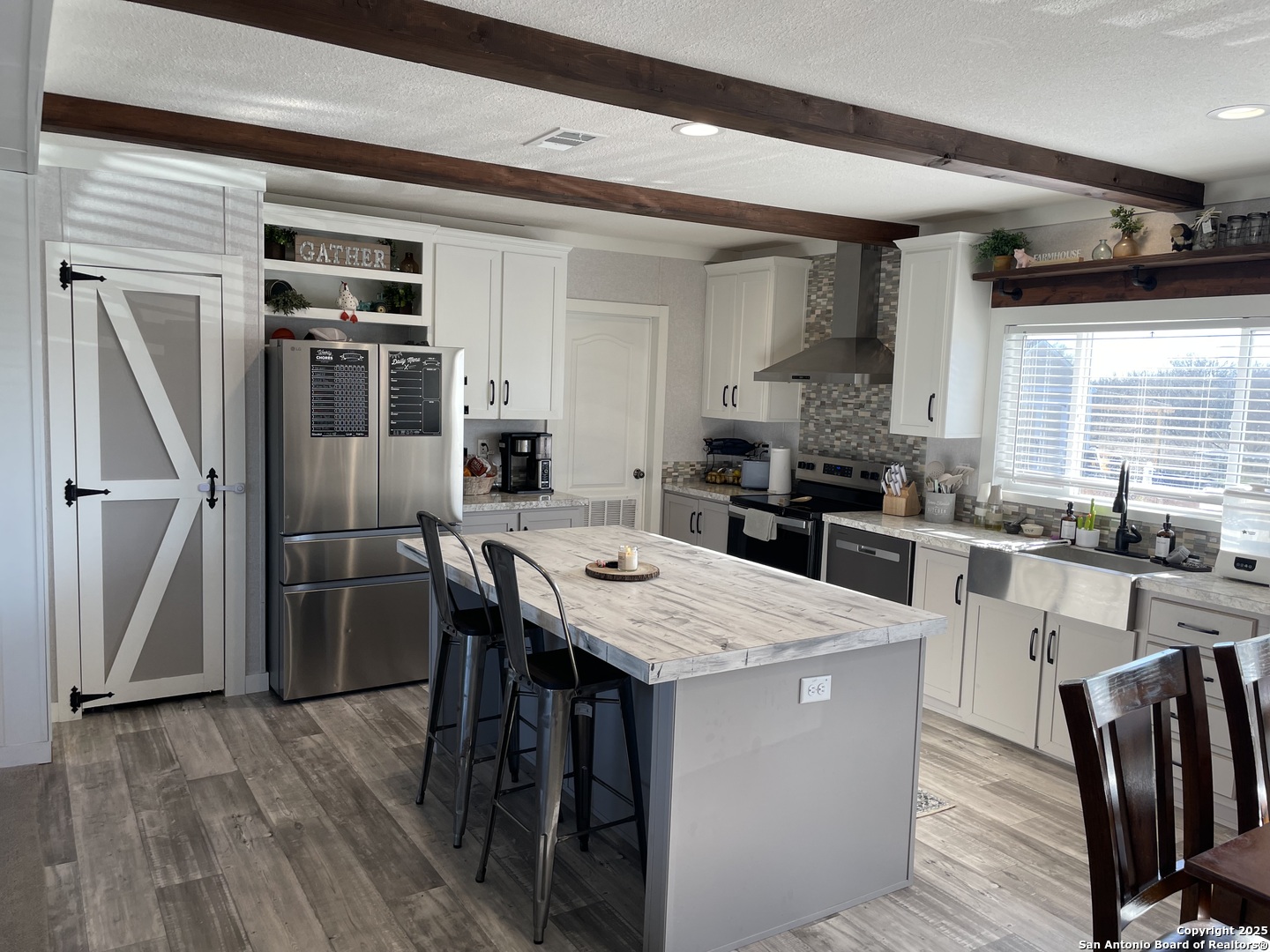 342 PR 4653 Hondo, TX 78861 - Photo 8 of 35 a kitchen with stainless steel appliances kitchen island granite countertop a refrigerator a stove a sink a dining table and chairs