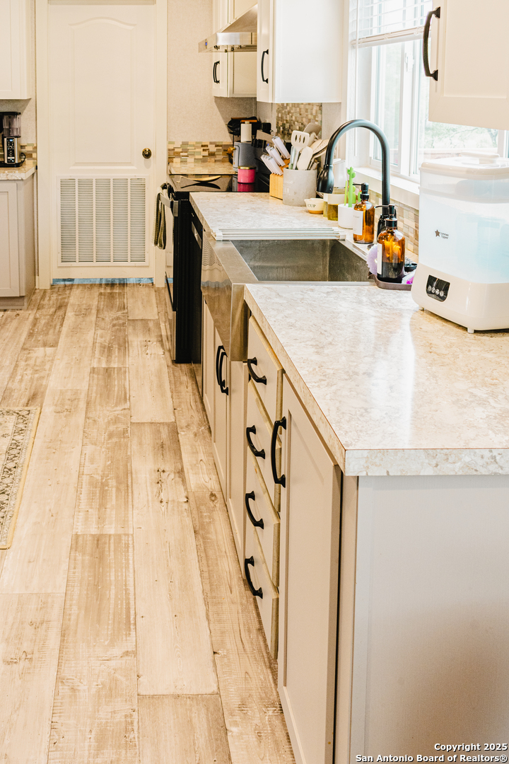 342 PR 4653 Hondo, TX 78861 - Photo 10 of 35 a kitchen with granite countertop a sink and a stove