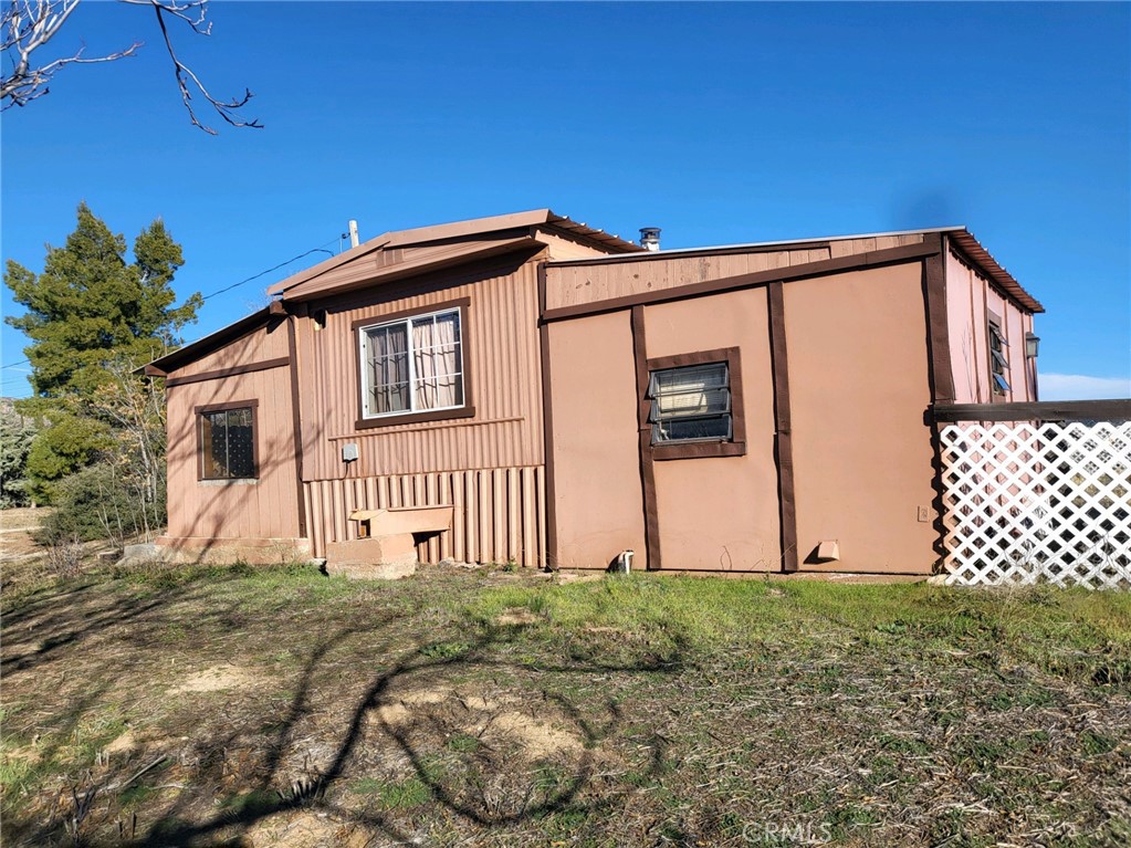 60075 Yucca Valley Road Anza, CA 92539 - Photo 1 of 1 a front view of a house with a yard