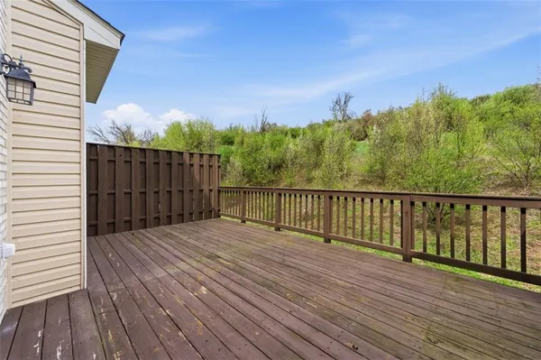 a balcony with wooden floor and fence