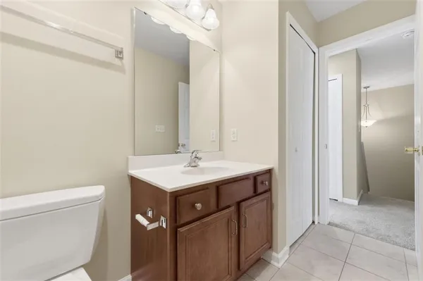 a bathroom with a sink toilet and mirror