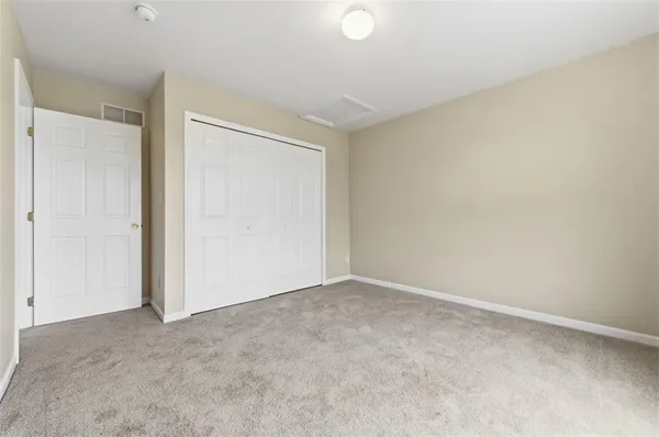 an empty room with closet area