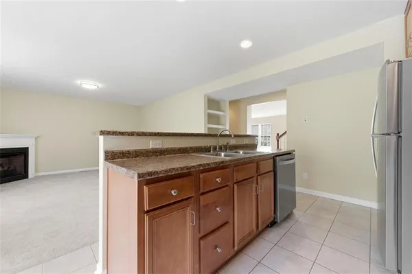 a kitchen with a sink and a refrigerator