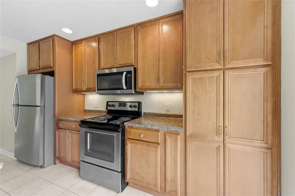 a kitchen with a refrigerator sink and microwave