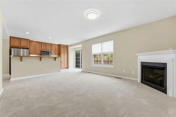 a view of a livingroom with a fireplace and window