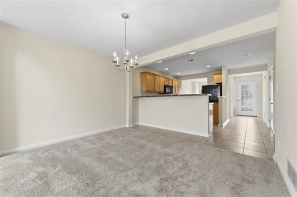 a view of a kitchen with a sink and a chandelier