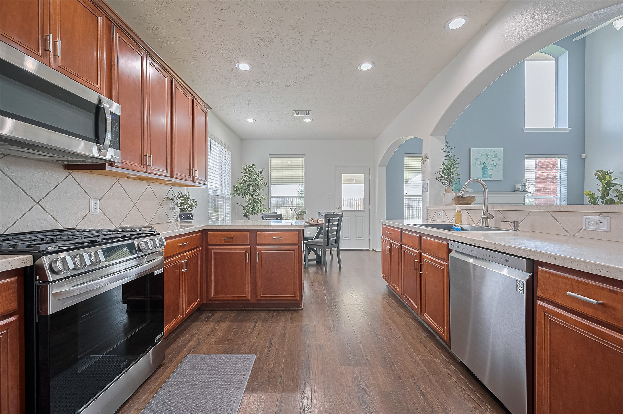 21506 Avalon Queen Drive Spring, TX 77379 - Photo 17 of 46 Enjoy cooking in a spacious kitchen with rich wood cabinetry, stainless steel appliances, and ample countertop space.