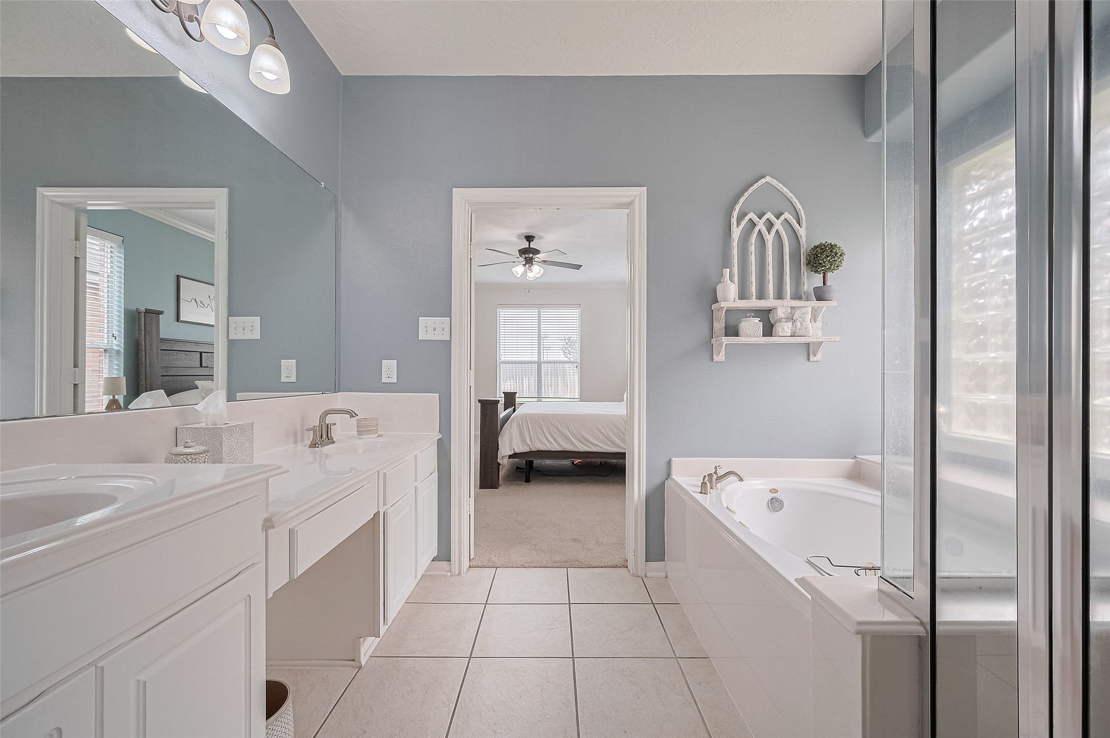 21506 Avalon Queen Drive Spring, TX 77379 - Photo 28 of 46 Step into your private spa-like sanctuary with soothing blue walls and pristine white cabinetry.