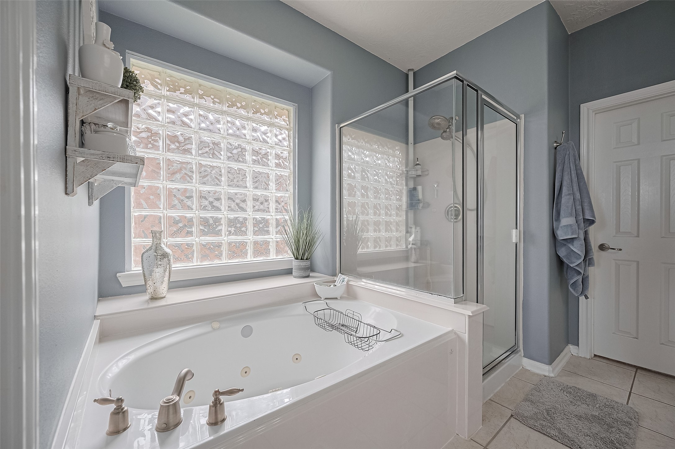 21506 Avalon Queen Drive Spring, TX 77379 - Photo 31 of 46 The deep, inviting soaking tub promises ultimate relaxation—perfect for unwinding after a long day.
For a quick refresh, step into the separate, sleek glass-enclosed walk-in shower.