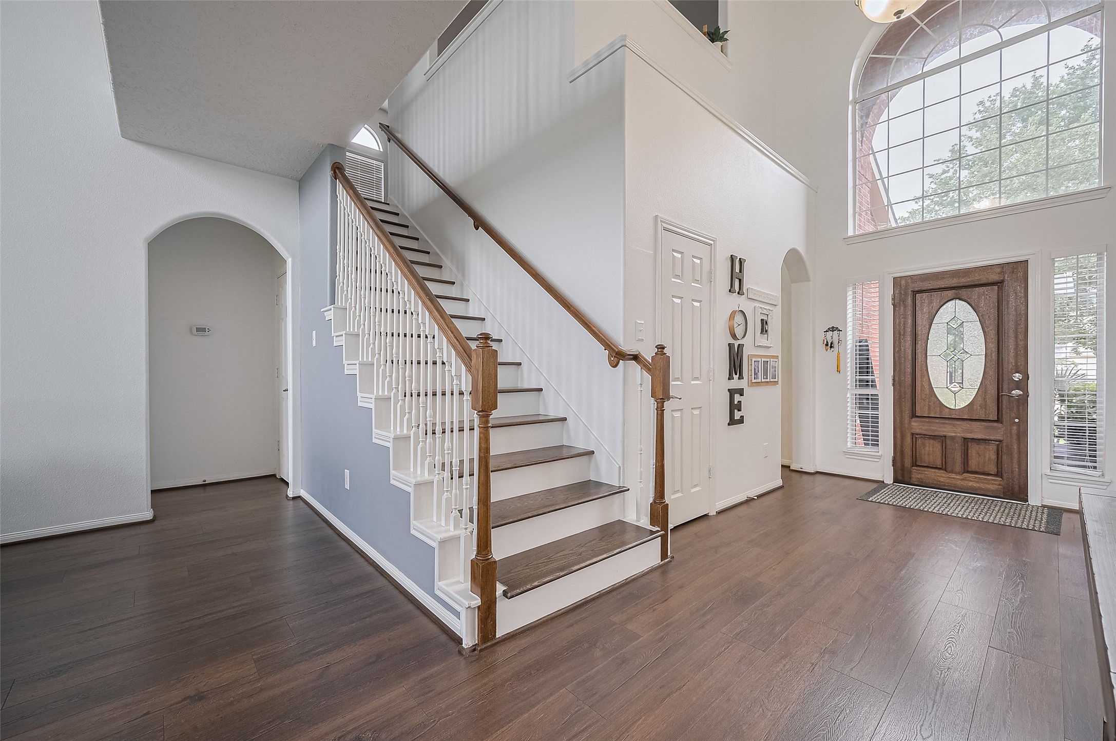 21506 Avalon Queen Drive Spring, TX 77379 - Photo 7 of 46 The elegant staircase and catwalk balcony create a striking focal point, while the arched window above the door floods the space with natural light