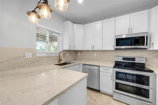 a kitchen with appliances cabinets and a window