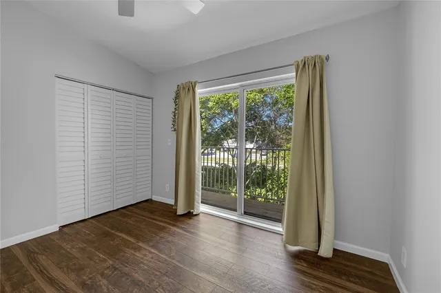 a view of a room with wooden floor and doors