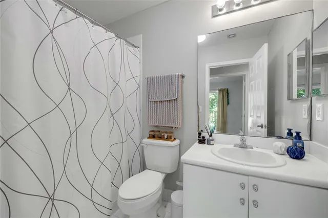 a bathroom with a sink toilet and mirror